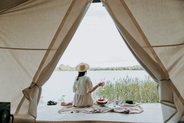person relaxing while glamping